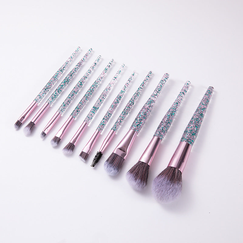 Set of makeup brushes with glittery handles on a white background