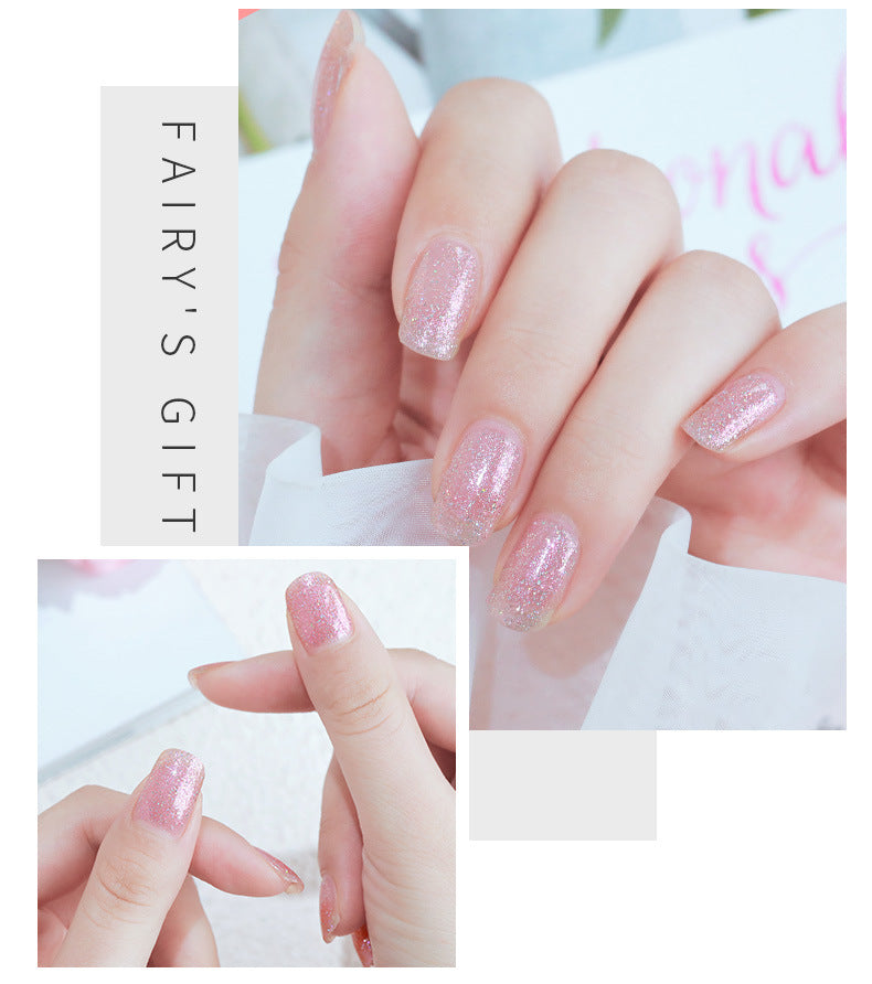 Close-up of hands with glittery pink nail polish and 'Fairy's Gift' branding.