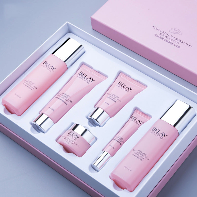 Set of pink skincare products with silver caps in a box, featuring the brand 'Belay'.