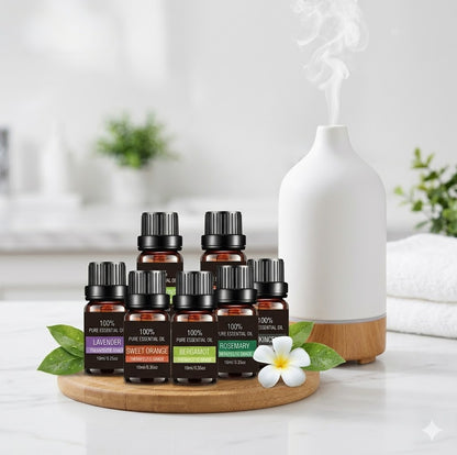 Collection of essential oil bottles on a wooden stand with a white diffuser in the background.